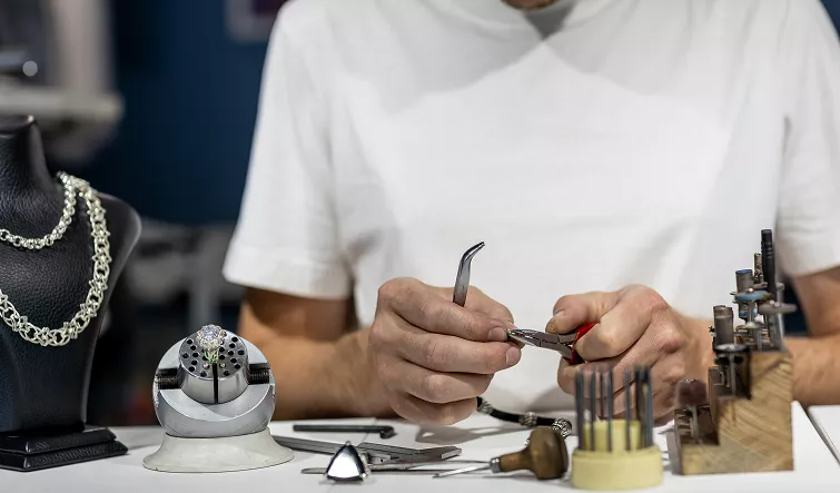Students shaping, texturing, and polishing fine silver pieces during a precious metal clay jewelry Classes