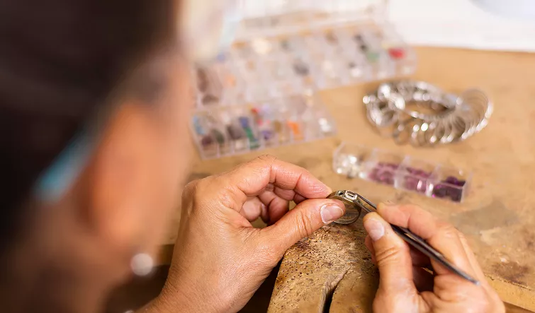 Students shaping, texturing, and polishing fine silver pieces during a precious metal clay jewelry Classes